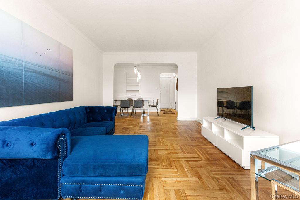 100-10 67th Road, Unit 6L Queens, NY 11375 - Photo 17 of 26 a living room with couches and a flat screen tv