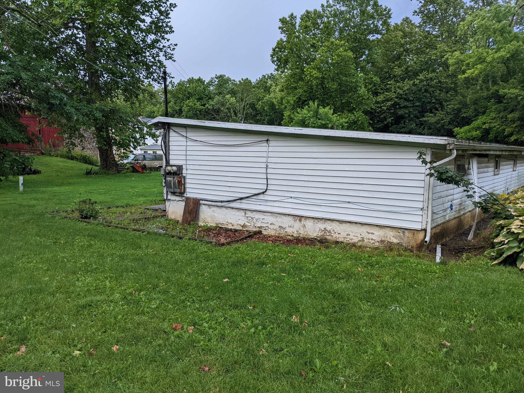 79 Spotts Mill Road Douglassville, PA 19518 - Photo 14 of 27 a view of a backyard with a garden