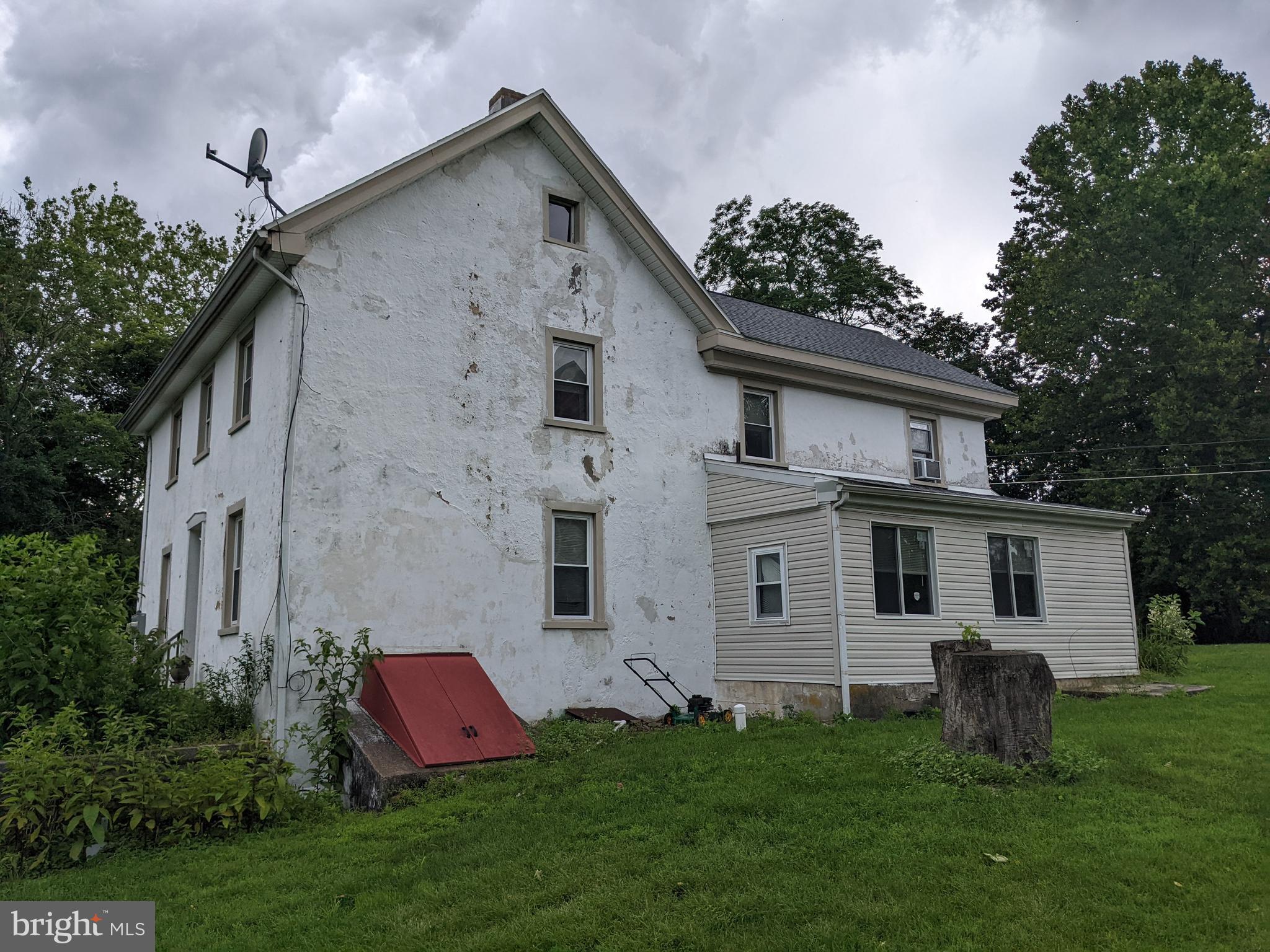 79 Spotts Mill Road Douglassville, PA 19518 - Photo 2 of 27 a view of a white house with a big yard and potted plants