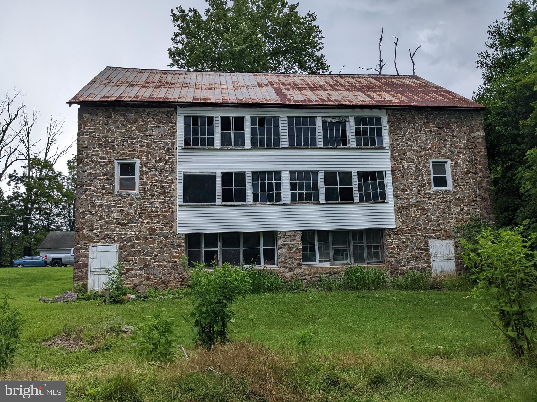 79 Spotts Mill Road Douglassville, PA 19518 - Photo 8 of 27 a front view of a house with a garden