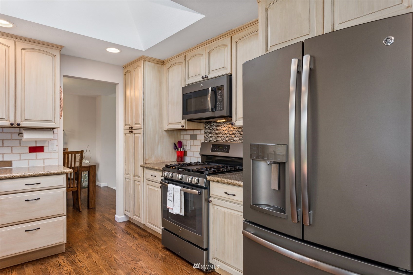 4805 Northeast 21st Street Renton, WA 98059 - Photo 9 of 40 a kitchen with stainless steel appliances a refrigerator stove and microwave