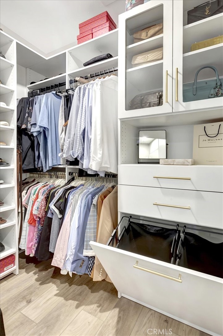 1810 West Bushell Street Anaheim, CA 92805 - Photo 18 of 36 a view of walk in closet with clothes and shoes