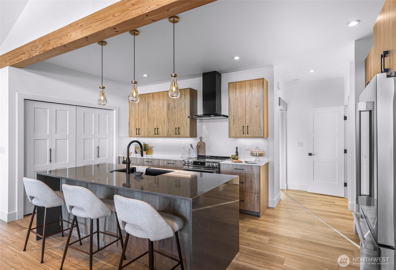 220 Skipping Stone Loop Lynden, WA 98264 - Photo 12 of 26 a kitchen with a table chairs refrigerator and cabinets
