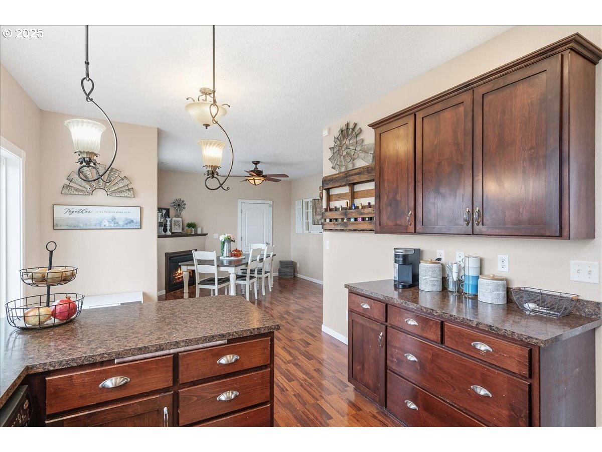 1010 Turtledove Loop Lebanon, OR 97355 - Photo 14 of 36 a kitchen with granite countertop cabinets and wooden floor