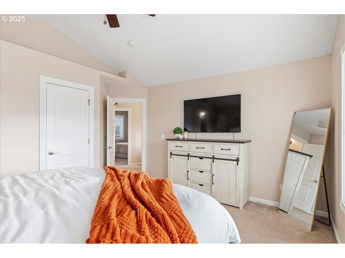 1010 Turtledove Loop Lebanon, OR 97355 - Photo 22 of 36 a bedroom with a bed and a flat screen tv