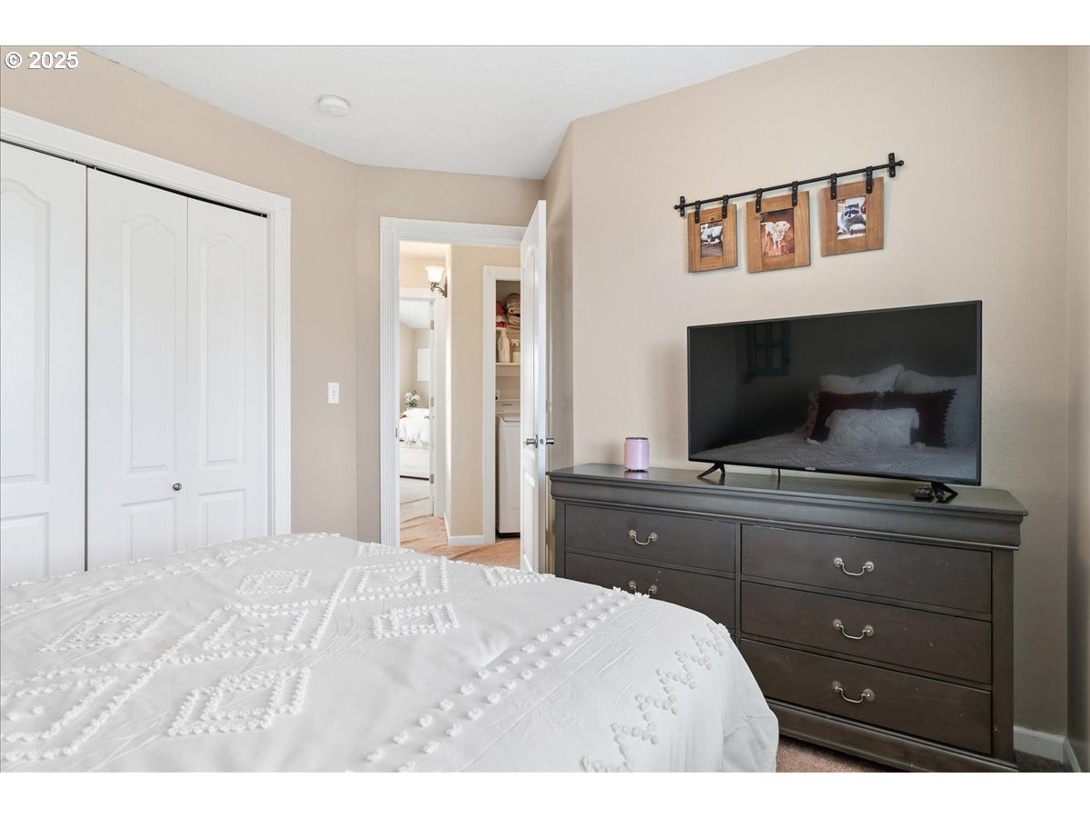 1010 Turtledove Loop Lebanon, OR 97355 - Photo 26 of 36 a bedroom with a bed and a flat screen tv