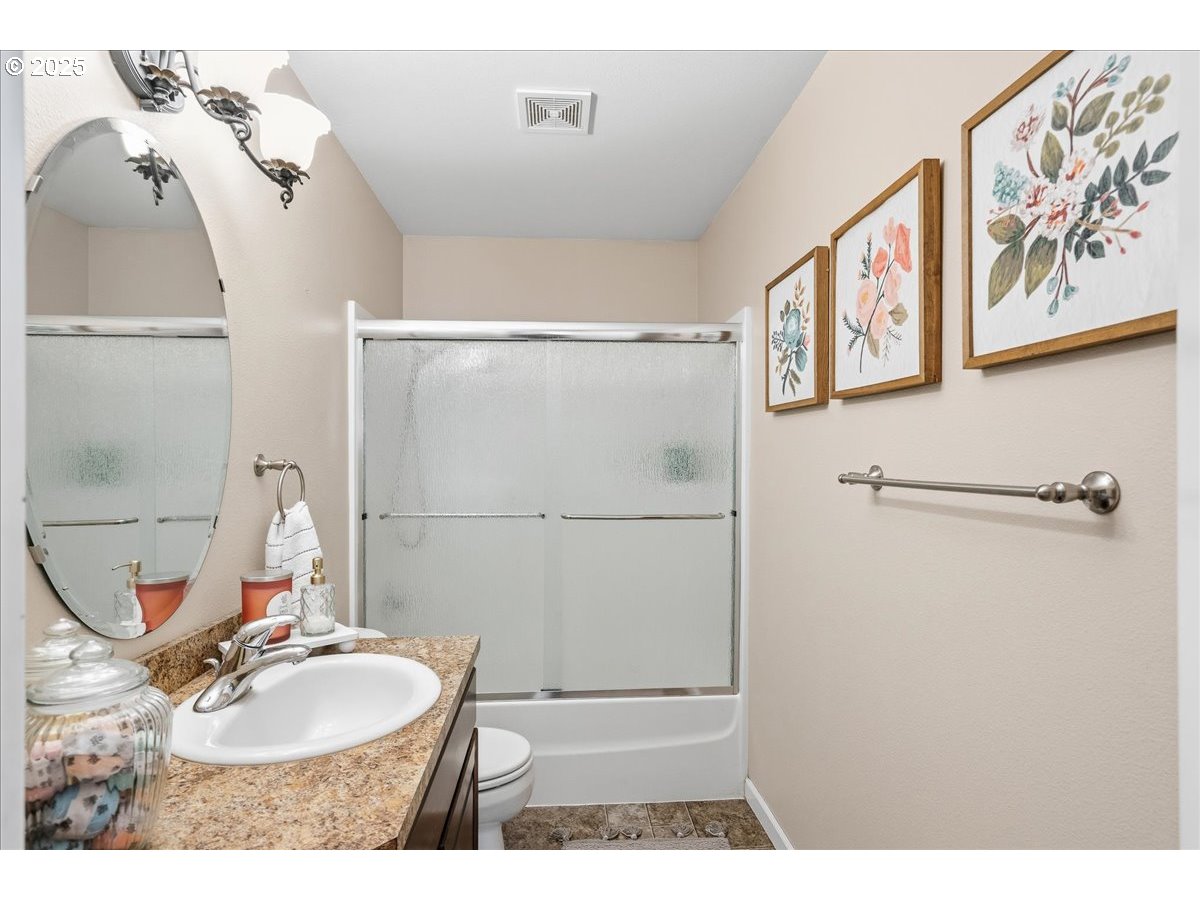1010 Turtledove Loop Lebanon, OR 97355 - Photo 27 of 36 a bathroom with a sink mirror vanity and toilet