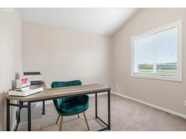 a view of a room with a table and chairs