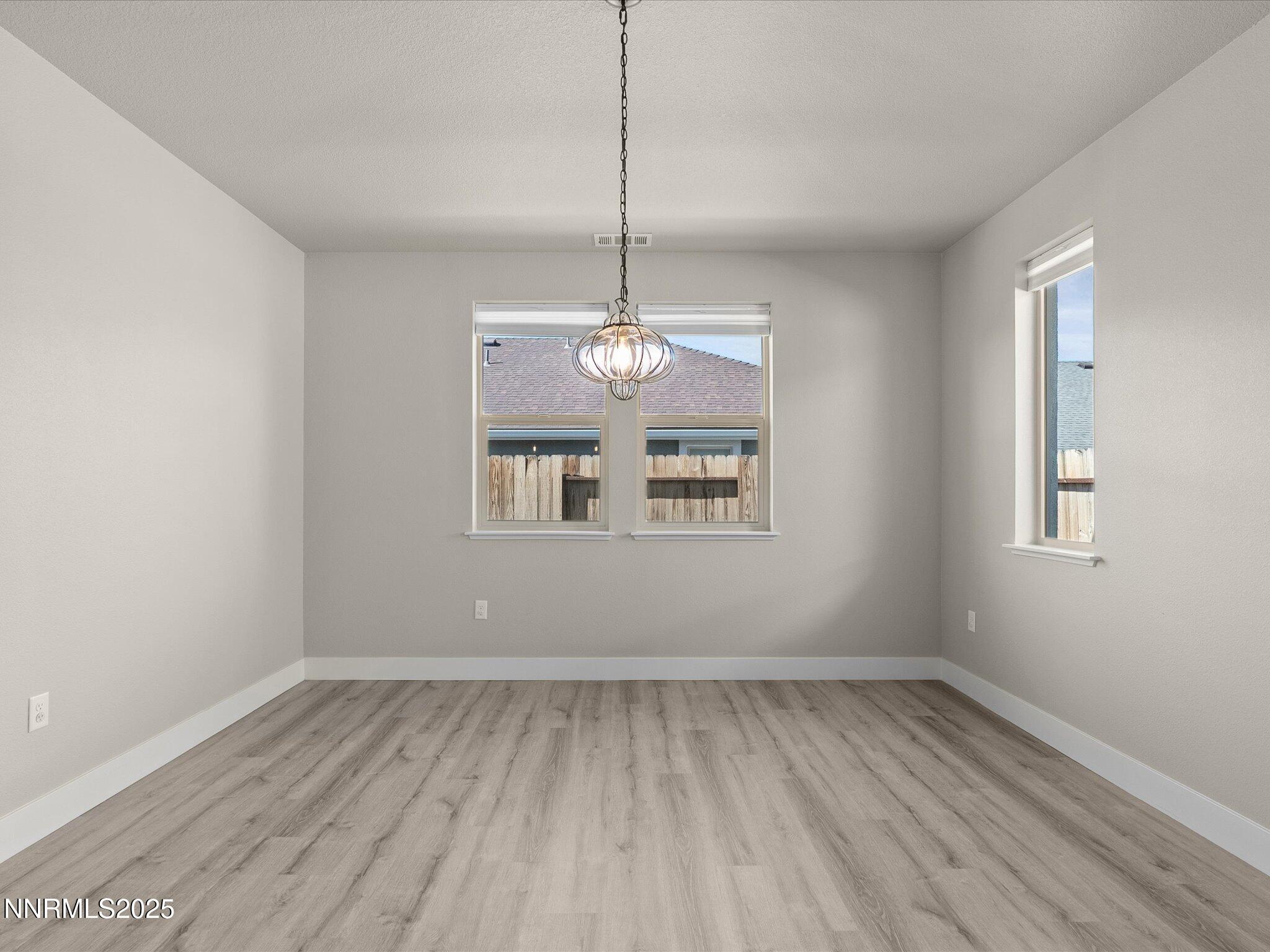 770 East Cottage Loop Gardnerville, NV 89460 - Photo 17 of 38 a view of a room with window wooden floor and a ceiling fan