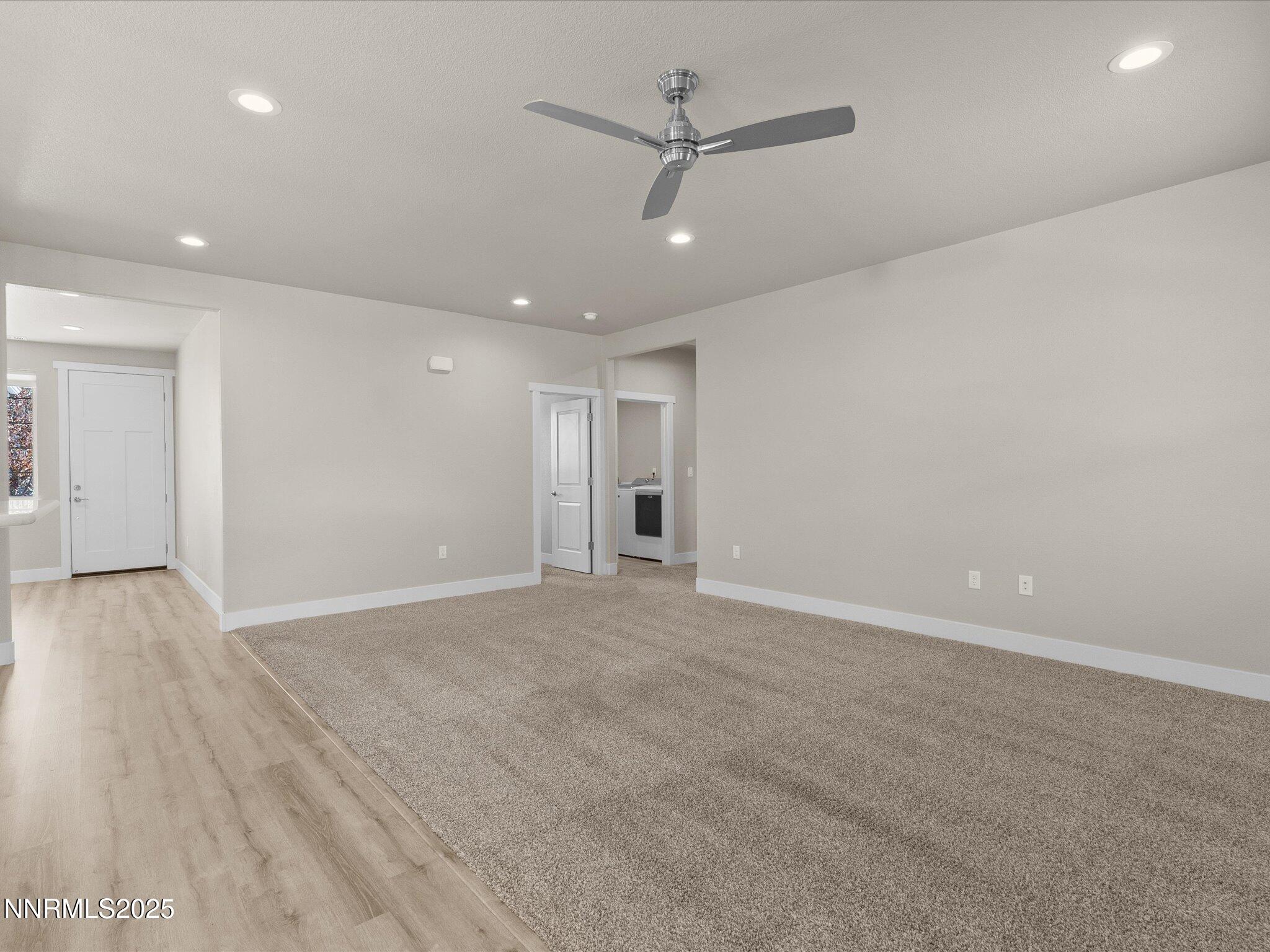 770 East Cottage Loop Gardnerville, NV 89460 - Photo 19 of 38 an empty room with wooden floor ceiling fan and windows