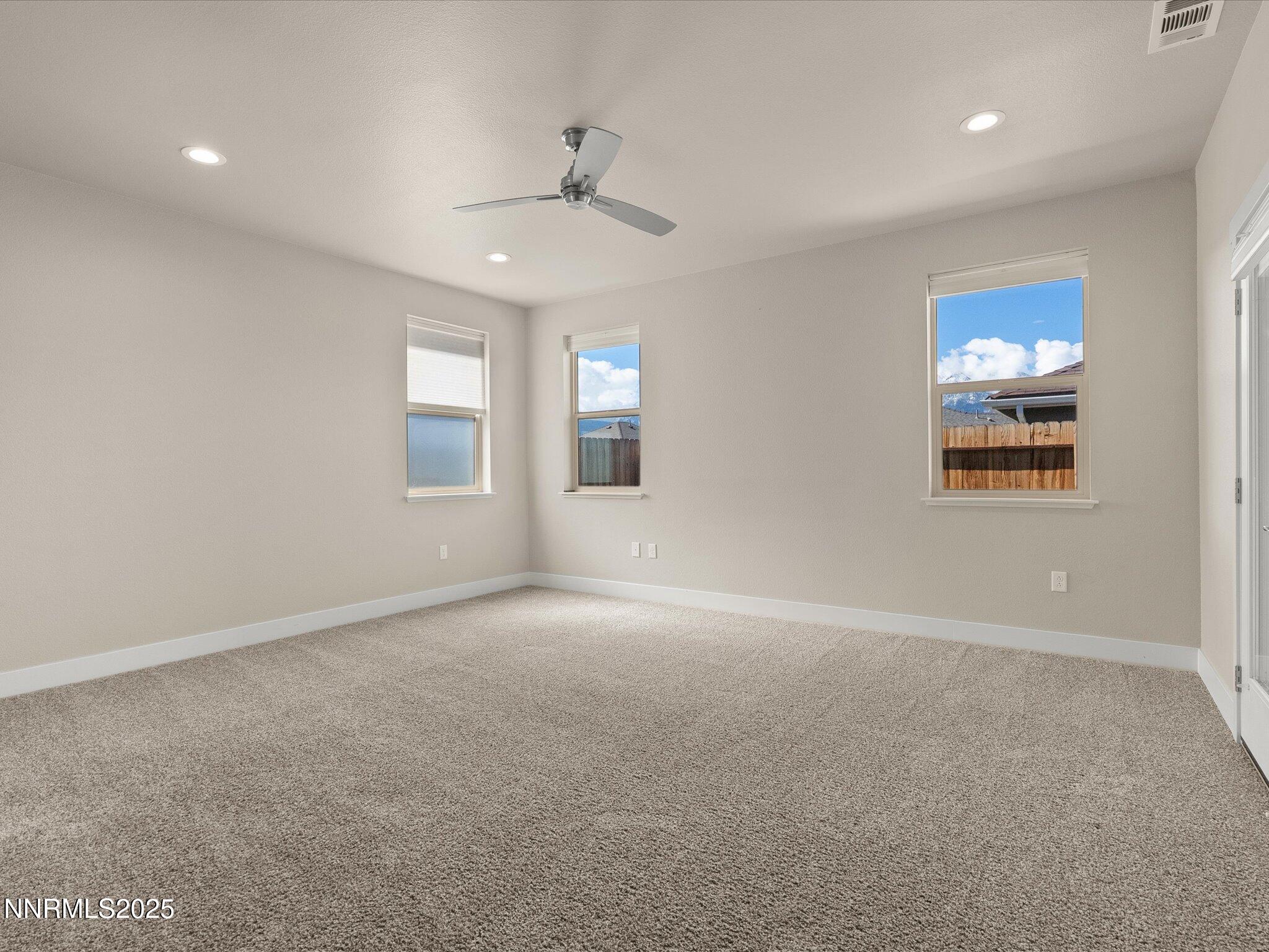 770 East Cottage Loop Gardnerville, NV 89460 - Photo 21 of 38 en empty room with windows and ceiling fan