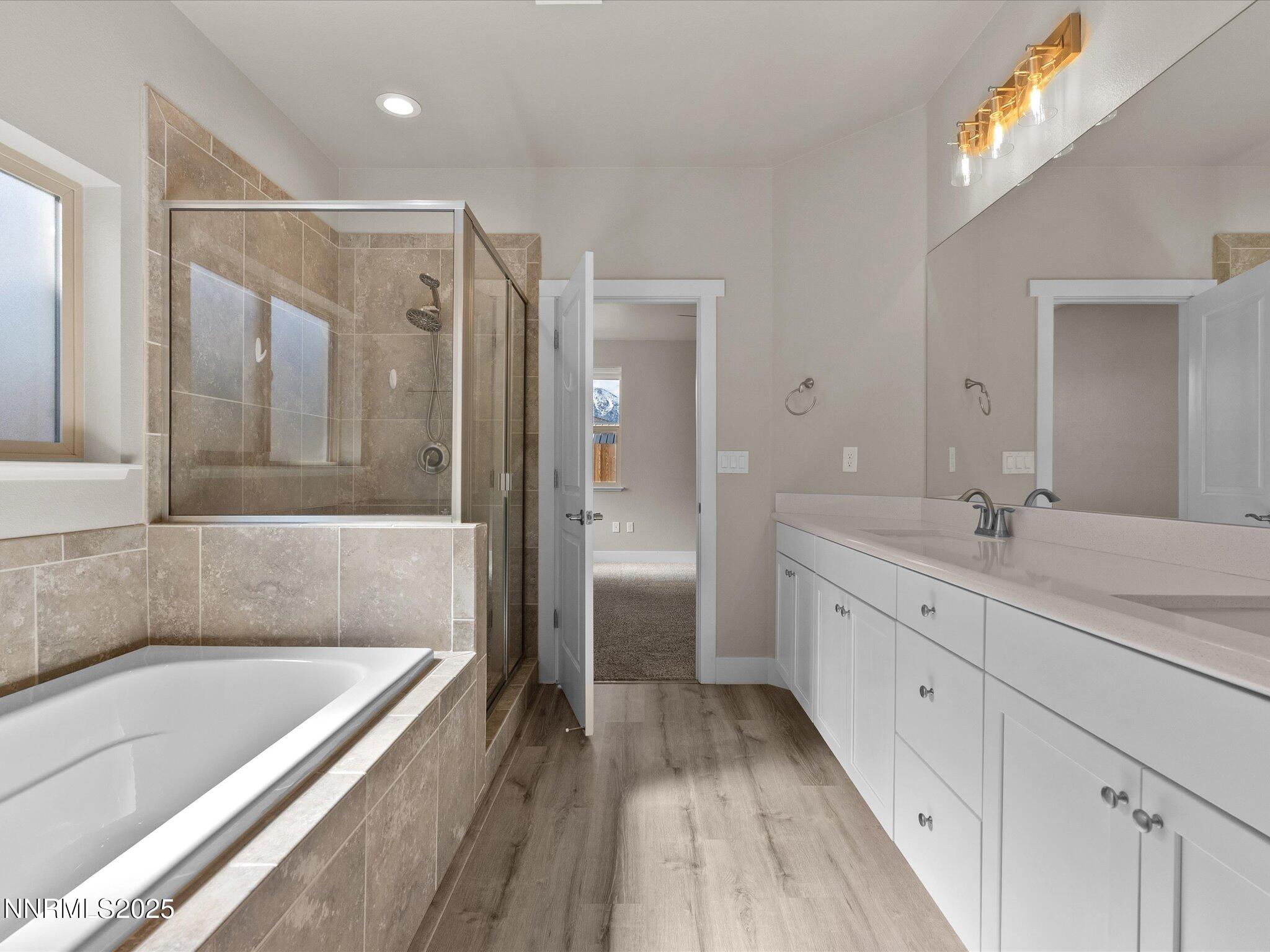 770 East Cottage Loop Gardnerville, NV 89460 - Photo 26 of 38 a spacious bathroom with a granite countertop tub shower double vanity and a sink