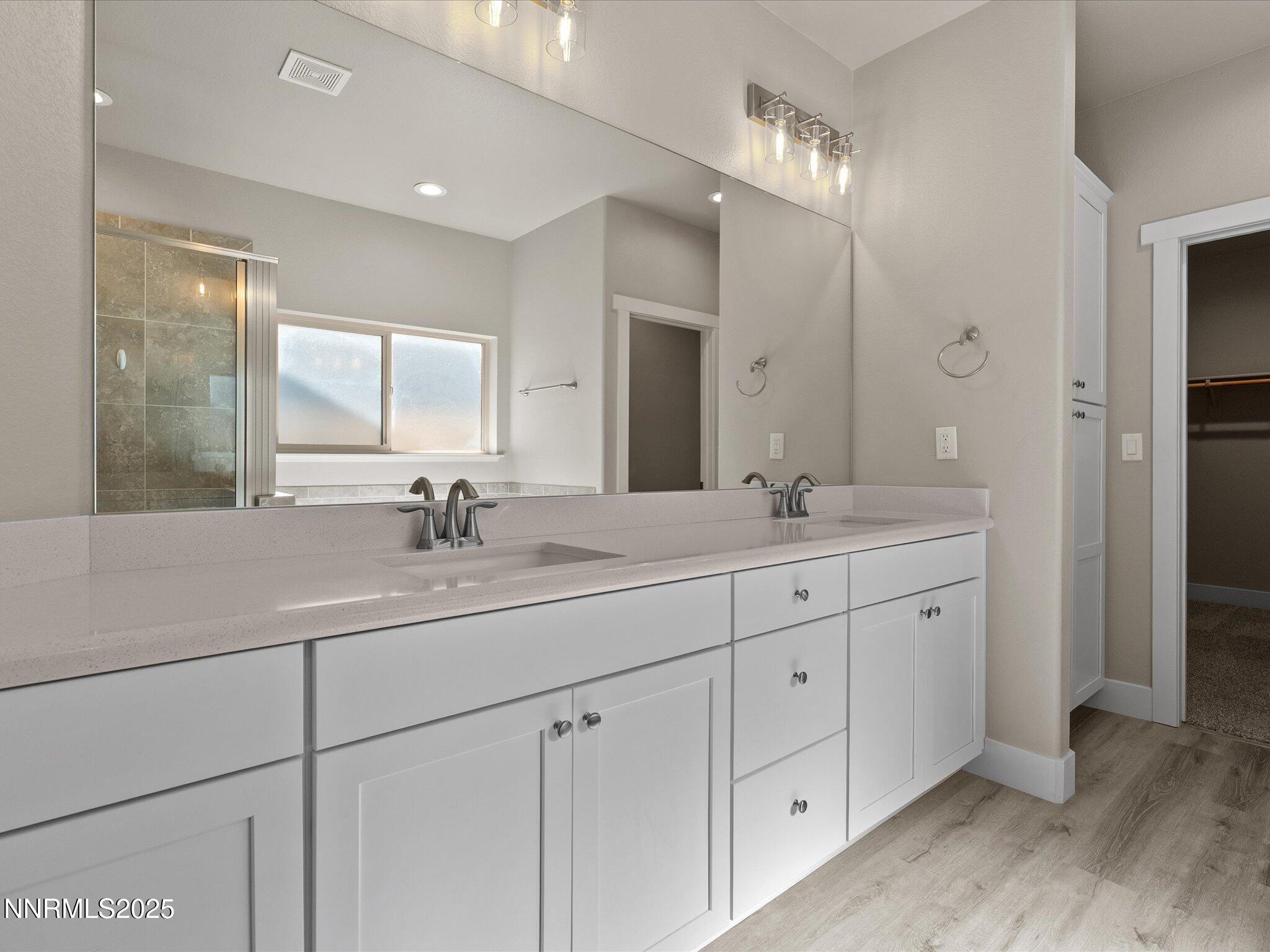 770 East Cottage Loop Gardnerville, NV 89460 - Photo 27 of 38 a bathroom with double sink and a mirror
