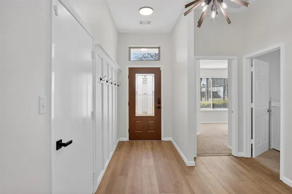 a view of a hallway view with wooden floor and staircase