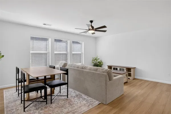 a living room with furniture a window and a table