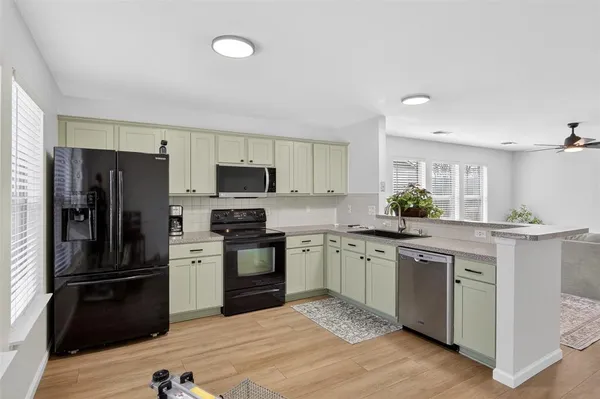 a kitchen with granite countertop stainless steel appliances and wooden cabinets