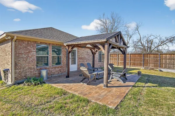 a view of a house with backyard patio and swimming pool