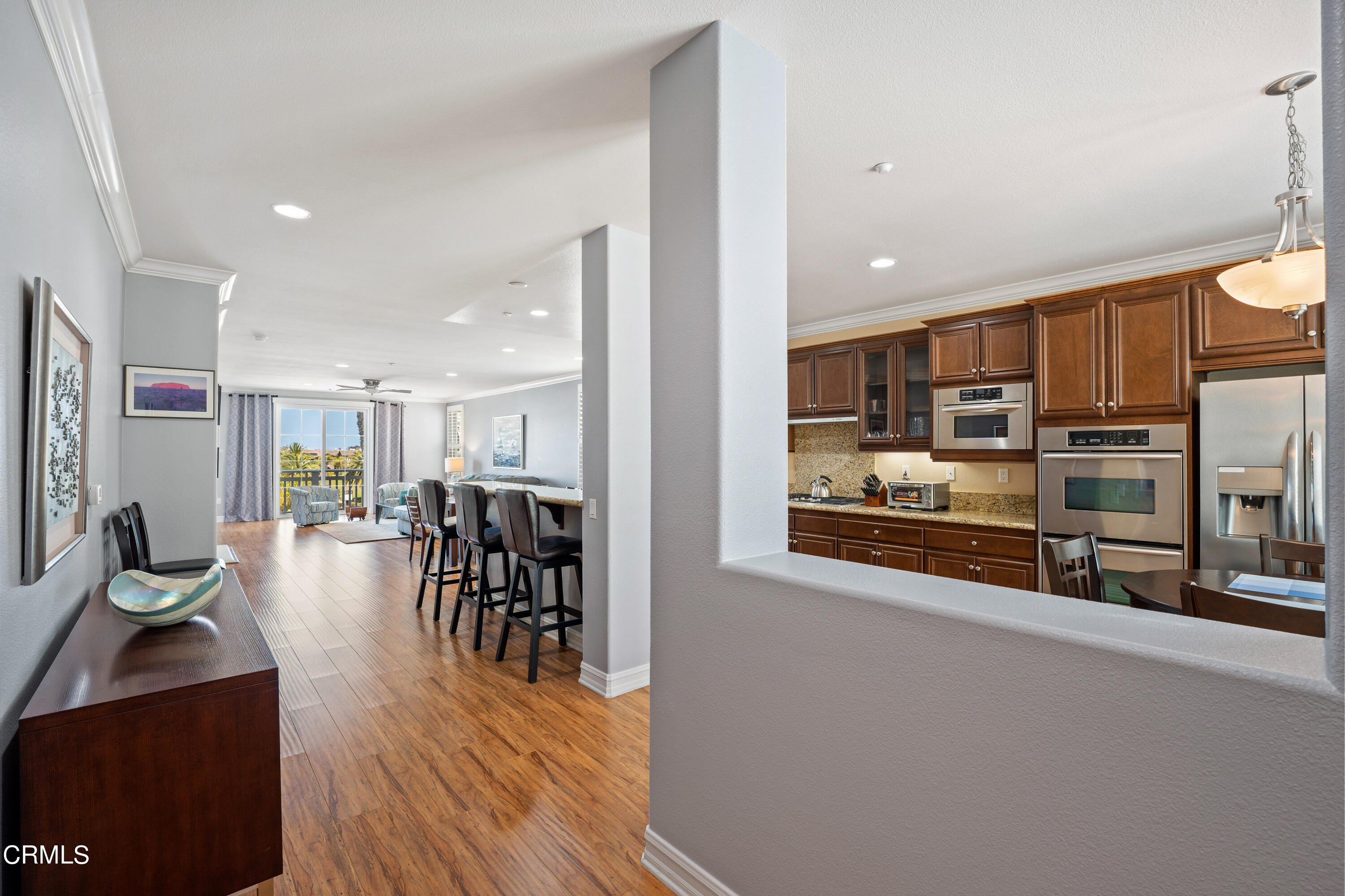 1541 Windshore Way Oxnard, CA 93035 - Photo 2 of 40 a open kitchen with stainless steel appliances granite countertop a refrigerator and stove top oven with wooden floor