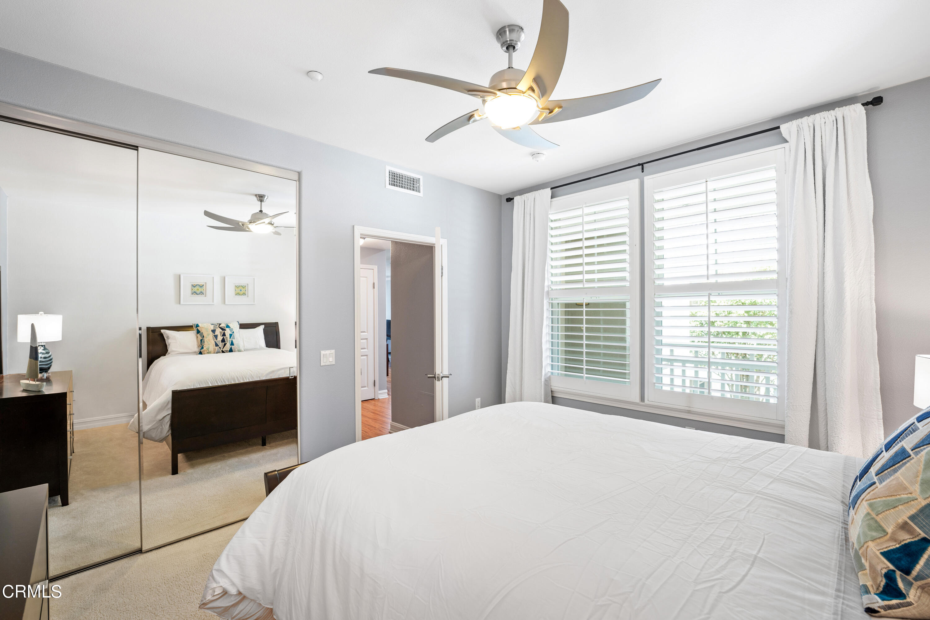 1541 Windshore Way Oxnard, CA 93035 - Photo 21 of 40 a bedroom with a large bed and a chandelier