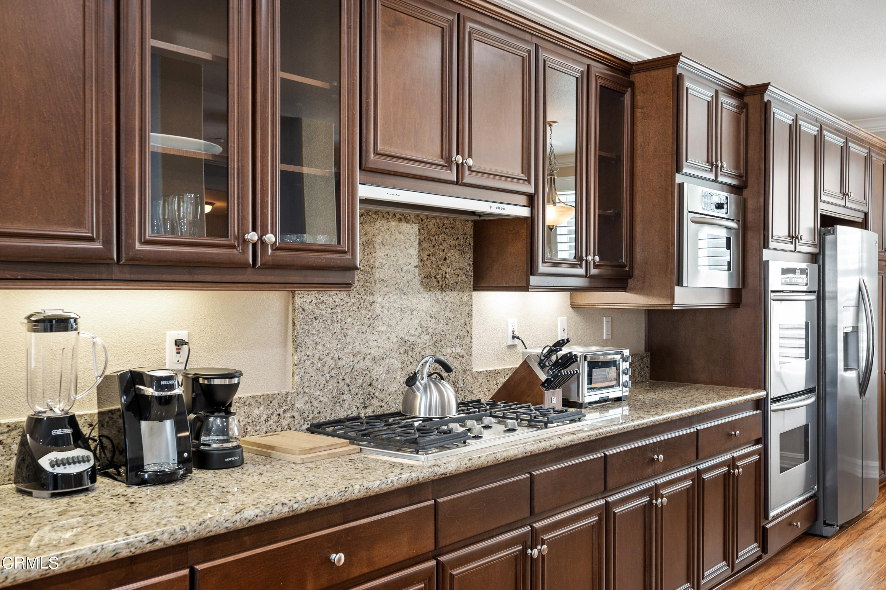 1541 Windshore Way Oxnard, CA 93035 - Photo 7 of 40 a kitchen with stainless steel appliances granite countertop a sink a stove and cabinets