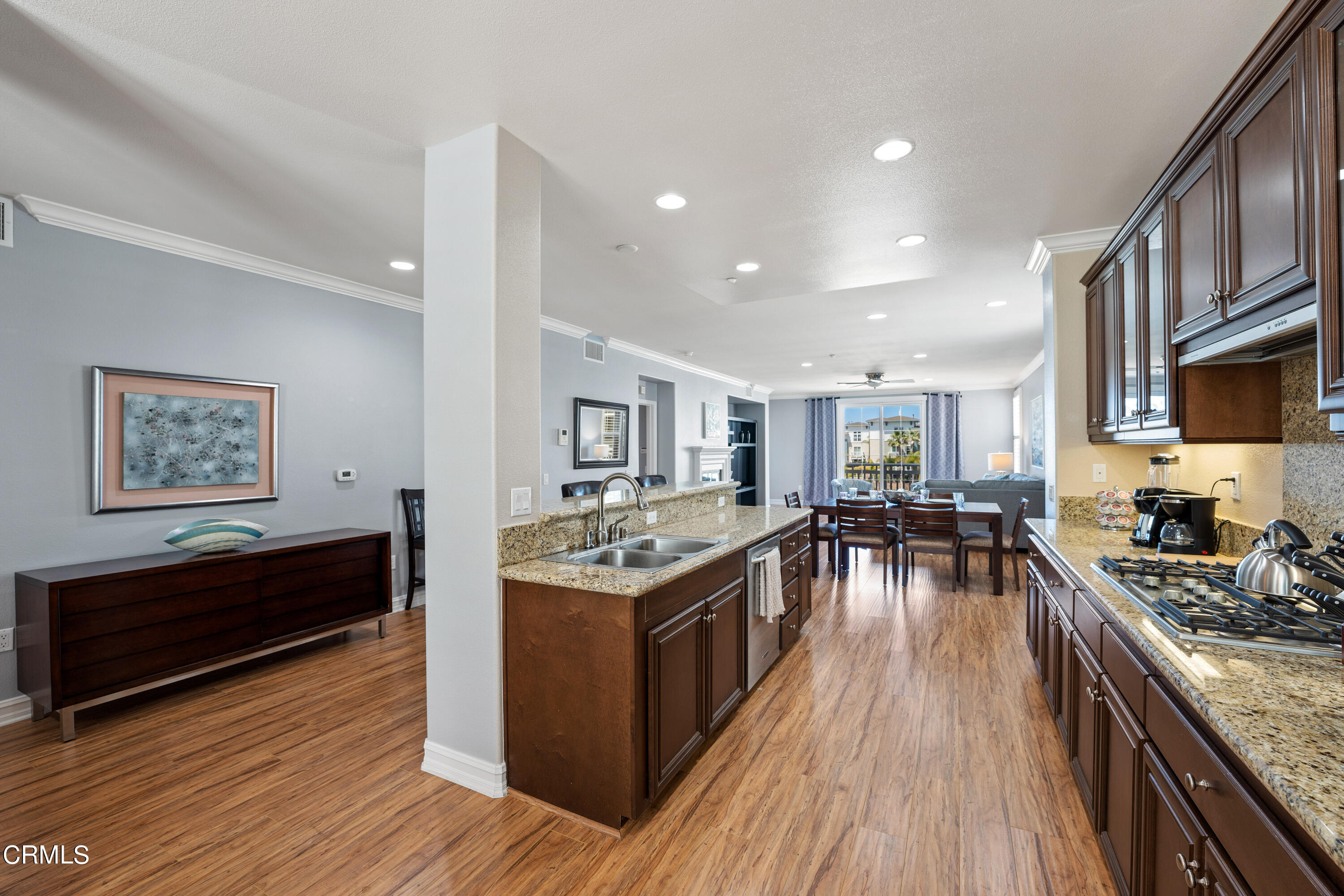 1541 Windshore Way Oxnard, CA 93035 - Photo 9 of 40 a kitchen with stainless steel appliances granite countertop wooden floors a stove and a sink