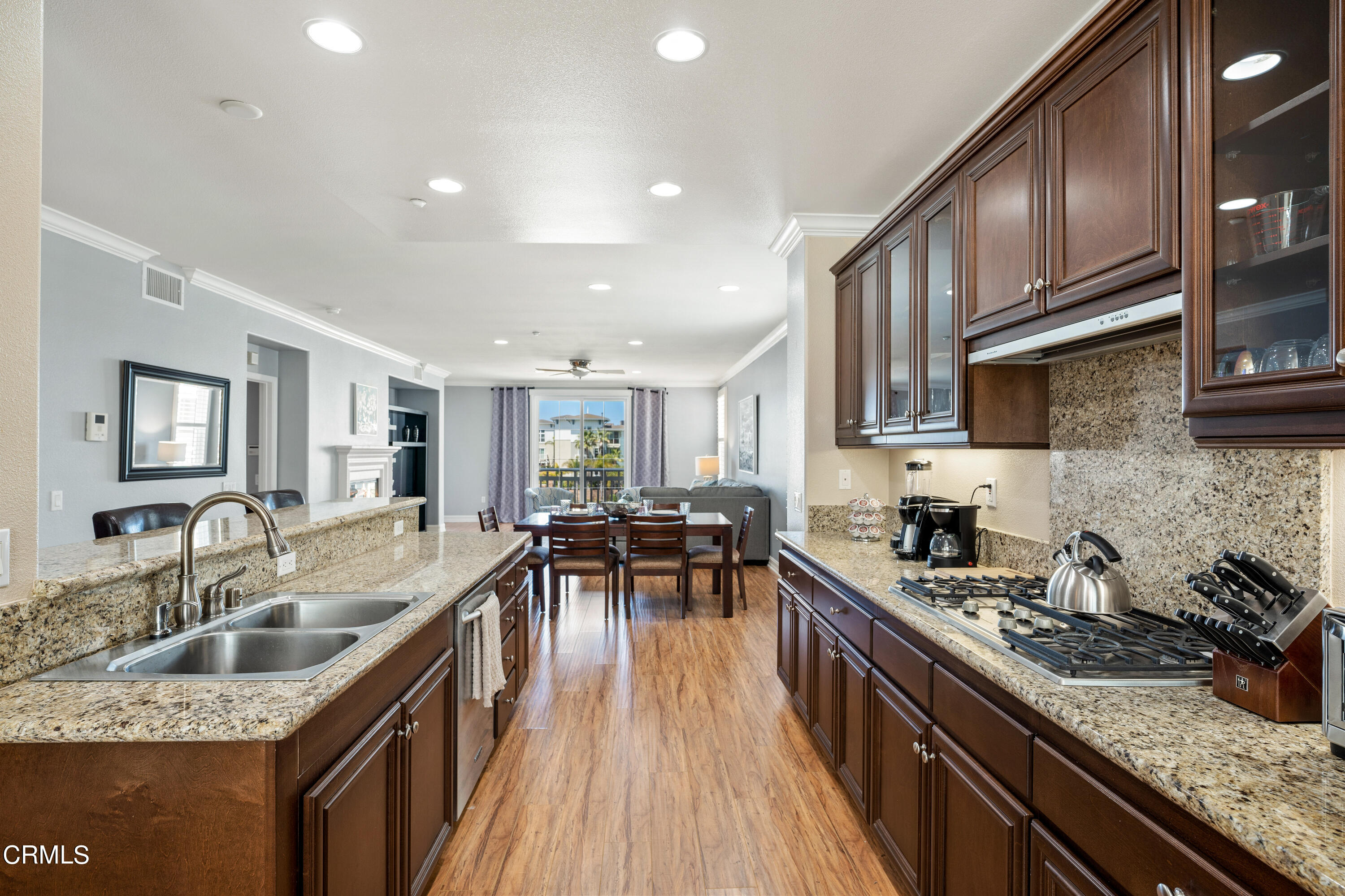 1541 Windshore Way Oxnard, CA 93035 - Photo 10 of 40 a kitchen with granite countertop sink stove top oven and cabinets