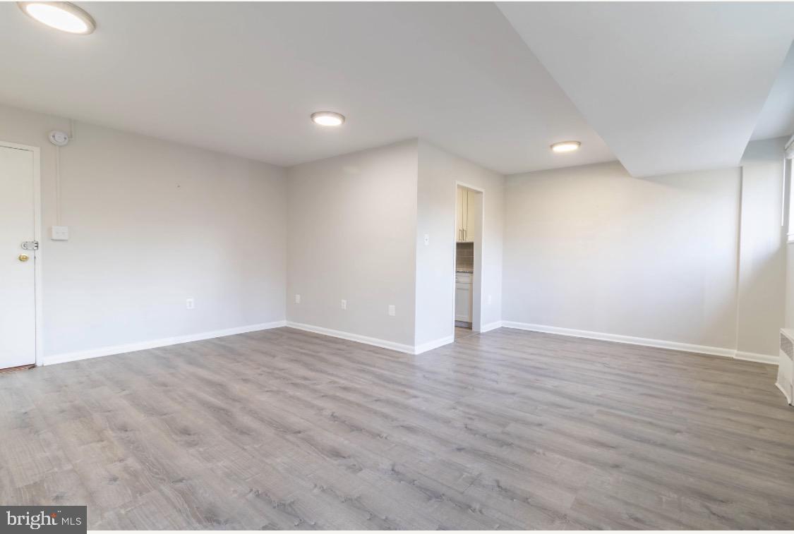 2400 41st Street Northwest, Unit 104 Washington, DC 20007 - Photo 6 of 13 a view of an empty room with wooden floor