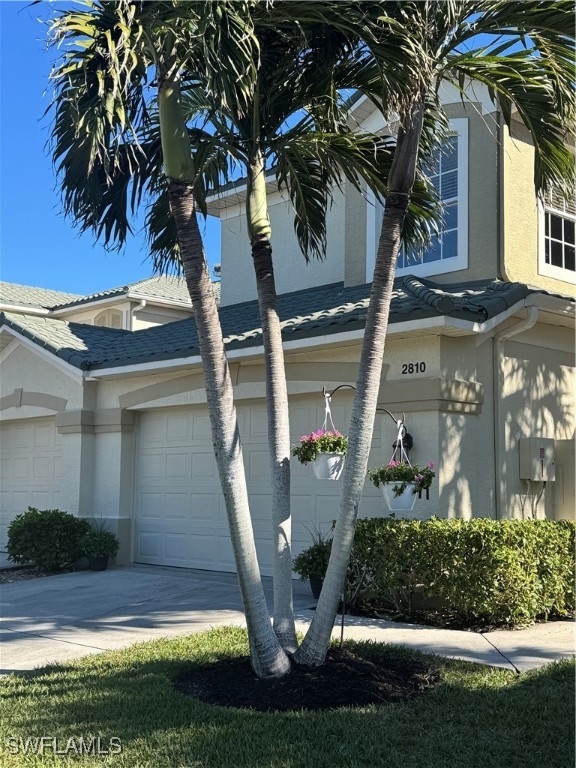 14511 Grande Cay Circle, Unit 2810 Fort Myers, FL 33908 - Photo 1 of 36 a front view of a house with garden