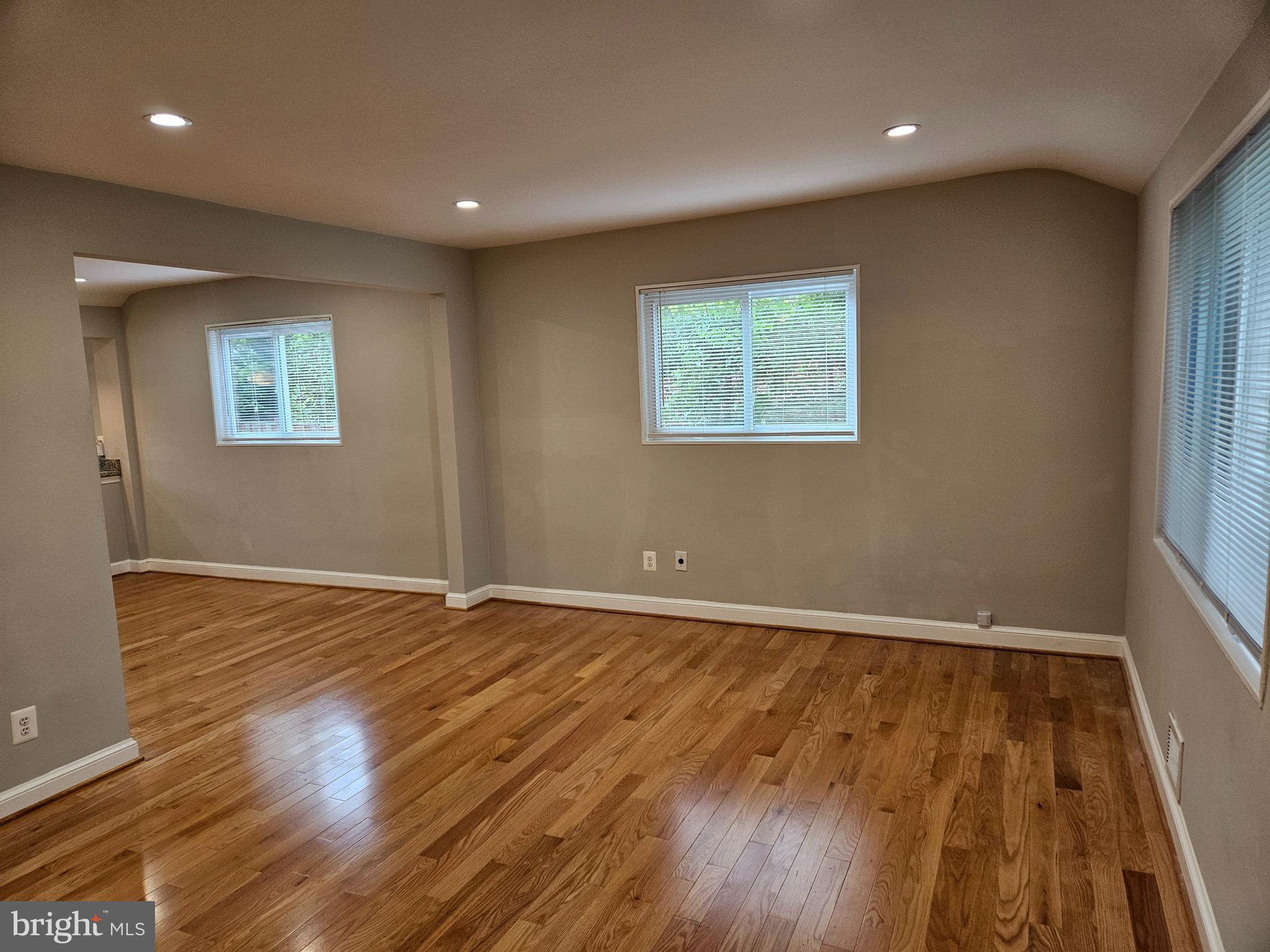 11102 Bucknell Drive Silver Spring, MD 20902 - Photo 6 of 14 an empty room with wooden floor and windows