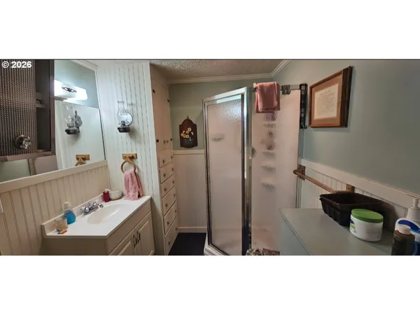 a bathroom with a sink toilet a mirror and shower