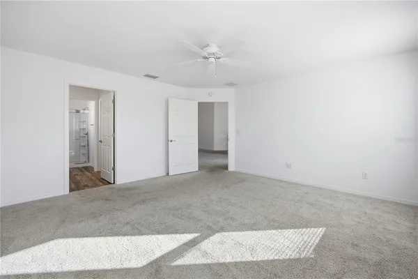a view of a big room with a ceiling fan