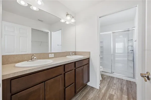 a bathroom with a double vanity sink and mirror