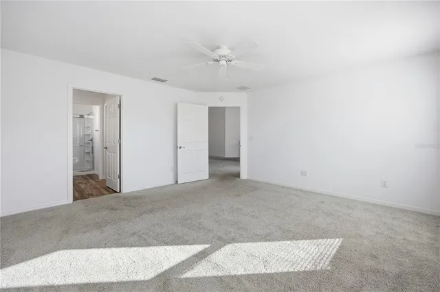 a view of a big room with a ceiling fan