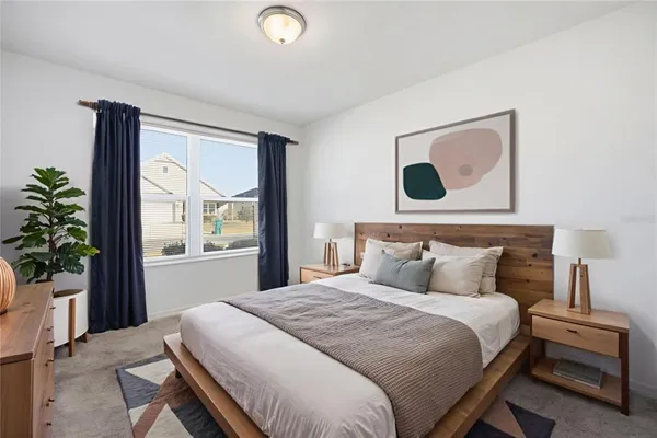 a bedroom with a bed and a large window