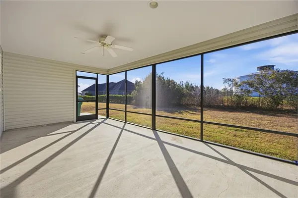a view of an empty room with a floor to ceiling window