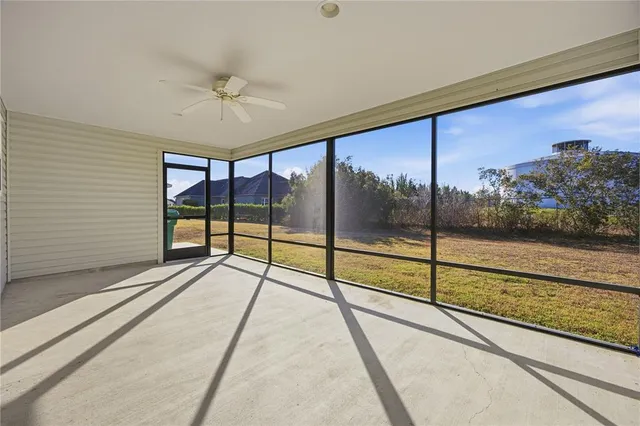 a view of an empty room with a floor to ceiling window