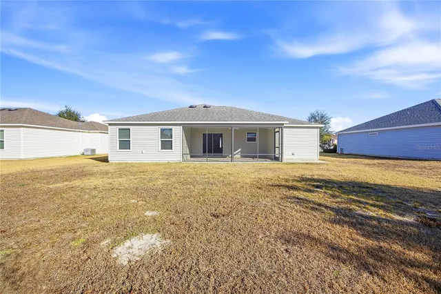 a view of house with yard and ocean view