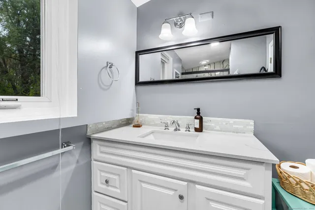 a bathroom with a window toilet and shower