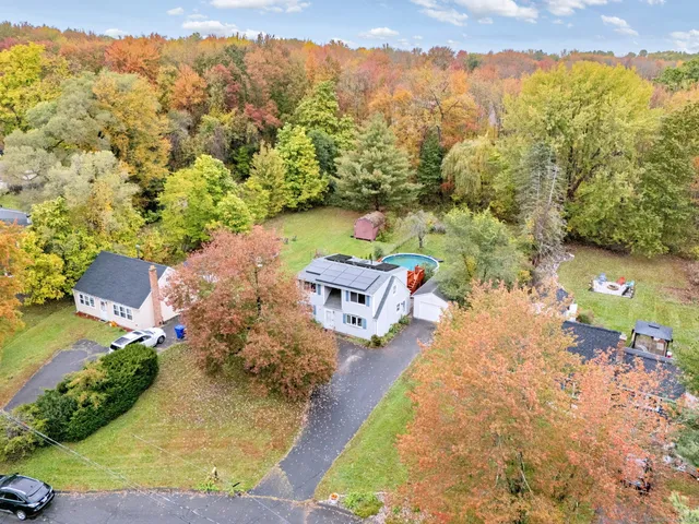 a backyard of a house with table and chairs