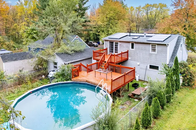 a backyard of a house with table and chairs