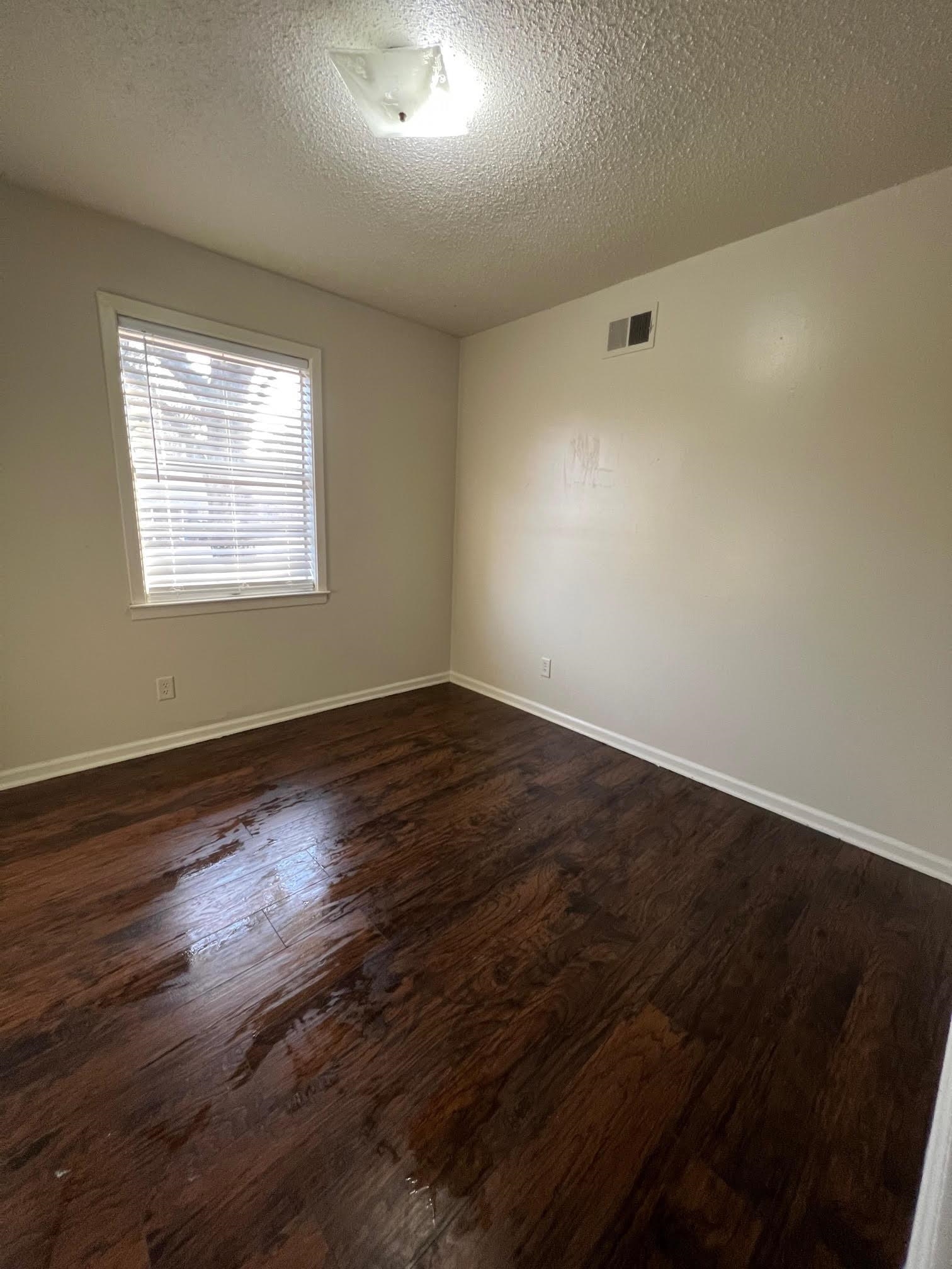 4178 Crain Road Memphis, TN 38128 - Photo 6 of 9 an empty room with wooden floor and windows