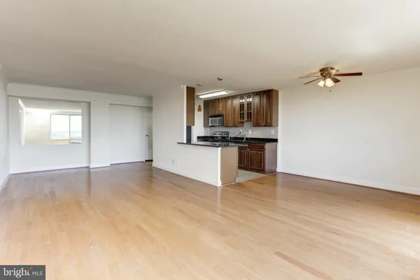 a view of a kitchen with a sink a microwave and cabinets