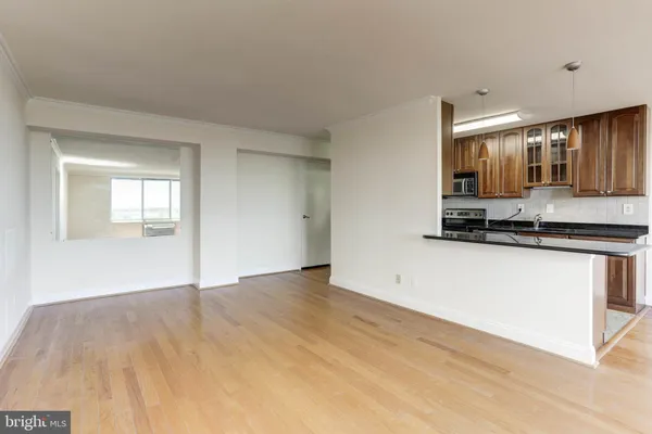 a view of a kitchen with wooden floor