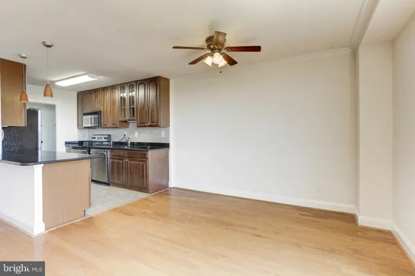 a kitchen with granite countertop a refrigerator stove top oven and sink