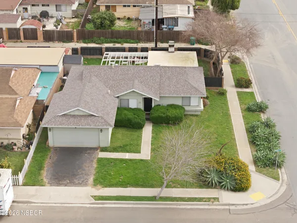 an aerial view of a house with a yard