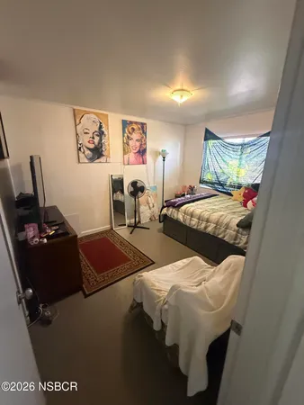 a bedroom with bed and window