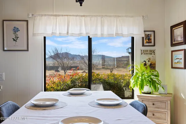 a view of a dining room with furniture and a potted plant