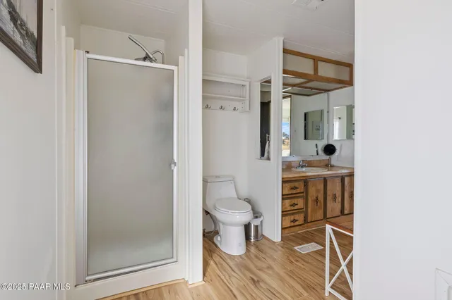 a bathroom with a toilet a sink and shower