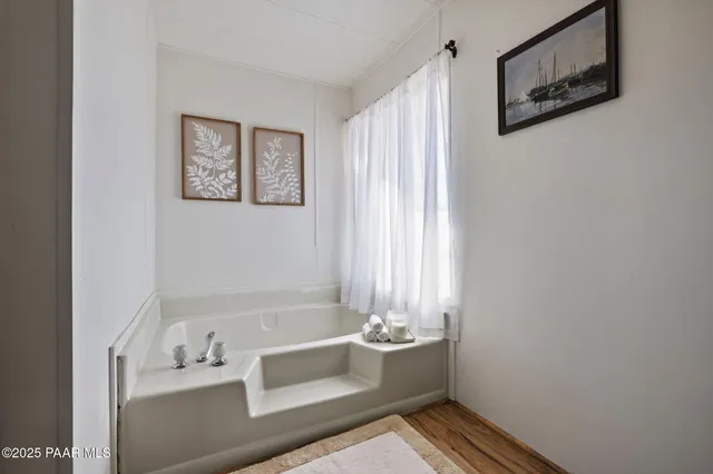 a bath tub sitting next to a white sink
