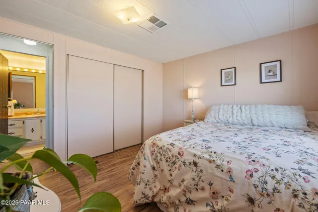 a bedroom with a bed and a painting on the wall